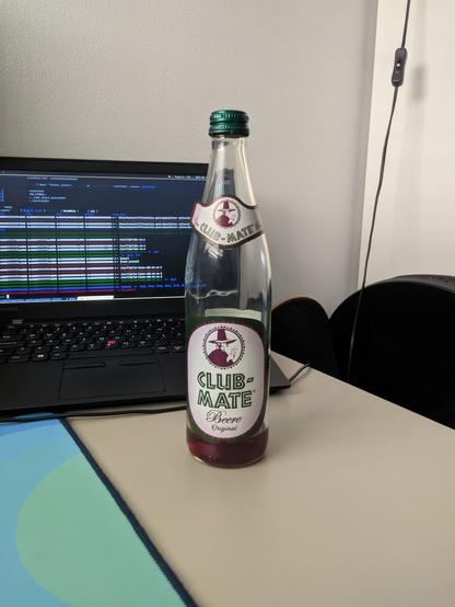 an almost empty bottle of Club-Mate Beere