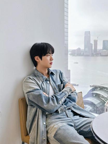 Jin posing in denim with a riverview behind him - Wootteo's Insta Feed