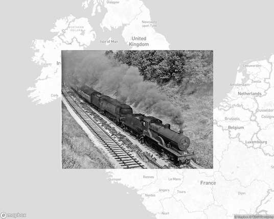 A photo of or from a train station from the linked website, overlaid on a cropped world map where it's located.