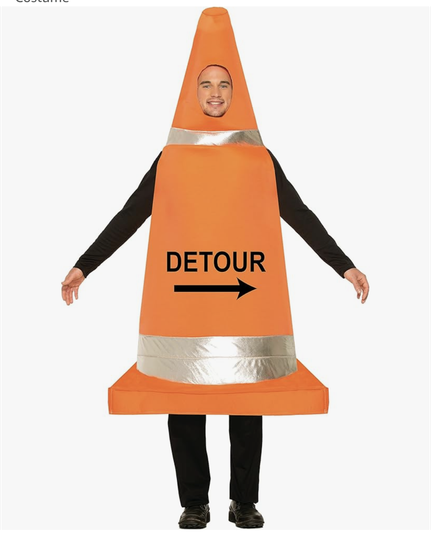 Man dressed in fancy dress traffic cone saying detour on it.