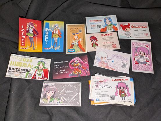They would distribute Business Cards of the Girl Personifying the Store :D ! There are just too many of them, it is basically impossible to collect Merchandise for all of them beyond finding a few random things for each, especially considering that they make things limited to 100 units or so, you need to pick one Girl or a few max Lol