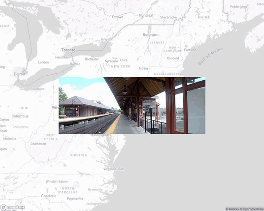 A photo of or from a train station from the linked website, overlaid on a cropped world map where it's located.