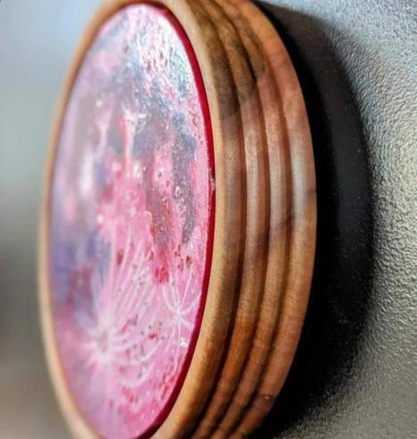 Strawberry Moon in a circular wooden frame.