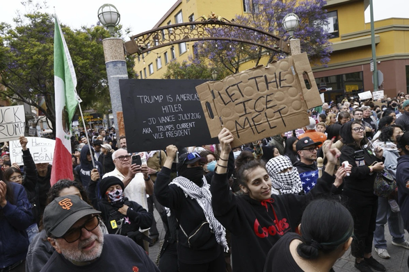 People hold a vigil at Fruitvale Station in Oakland, Calif. to show solidarity with demonstrations against ICE raids, on Tuesday, June 10, 2025. (Santiago Mejia/San Francisco Chronicle via AP)
