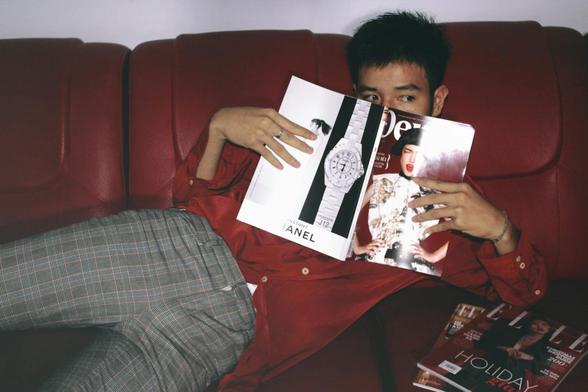 photography of a man holding magazine