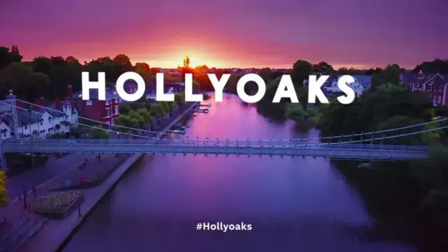 The Hollyoaks Title Card, "HOLLYOAKS" in white lettering on the background of a canal at sunset.