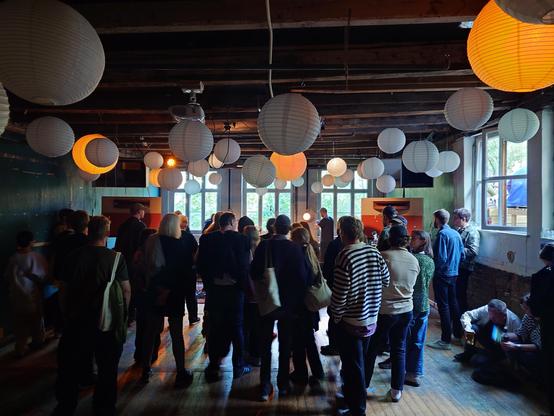 A photo of a small gathering of people inside a music venue