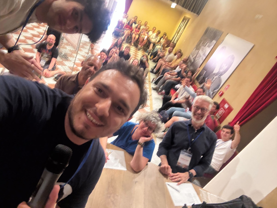 selfie with all of the isws2025 participants taken during the minute madness session on stage in the theater of BErtinoro castle.
