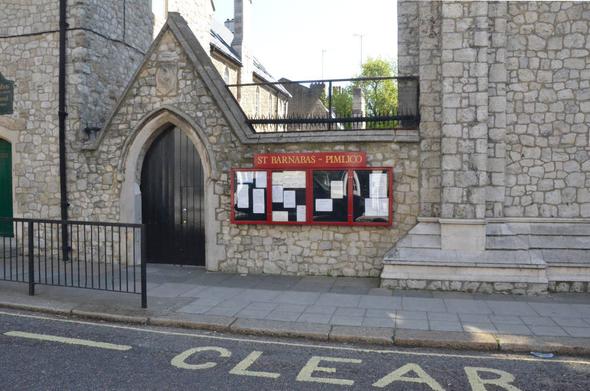 Entrance to courtyard, with church noticeboard