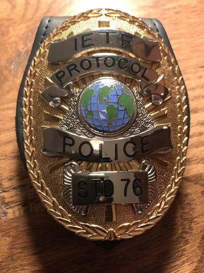 Photo of a badge that looks like an official US police badge labled as "IETF Protocol Police"