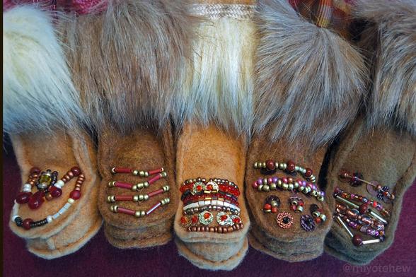 Five hand sewn boots with different beaded vamp designs. A red and gold theme with white and purple beads sewn in. Faux fur adds pizzazz and dramatic effect.