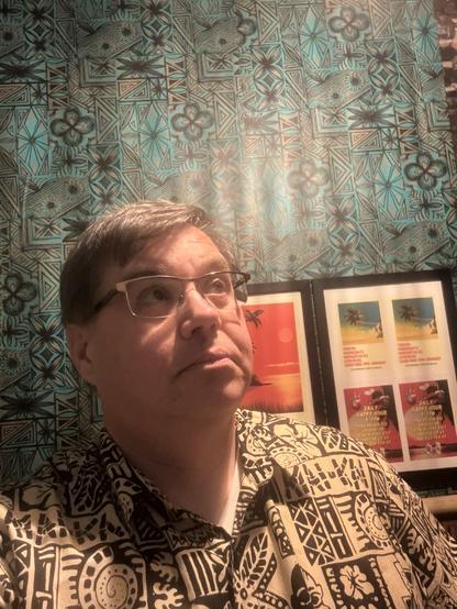 Selfie of me in the Tora Tiki  mens room looking up and over to the right (my left).