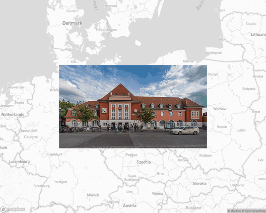 A photo of or from a train station from the linked website, overlaid on a cropped world map where it's located.