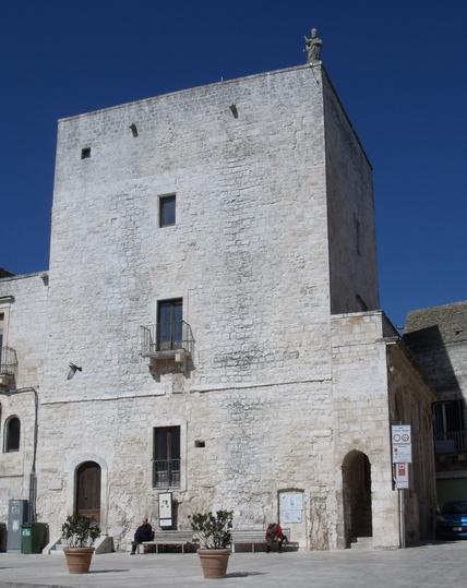 White stone, rectangular tower, shining in the sun.