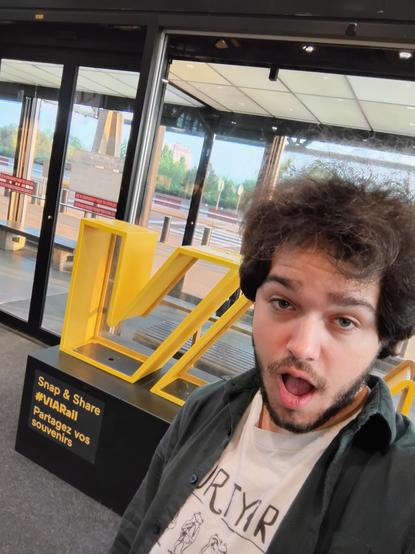 Me posing in front of a large VIA Rail sign
