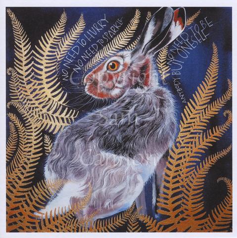 A hare with red fur on its head and grey on its back sits facing away from the viewer but with its head turned to one side, one eye facing in the viewer's direction. The hare is surrounded by gold fern leaves, and the inscription, woven into the fern, reads, No need to hurry, no need to sparkle, no need to be anybody but oneself. The background is dark blue.