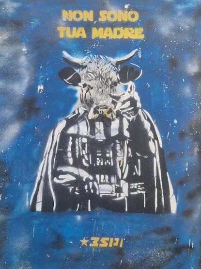Graffiti depicting Darth Vader with a cow’s face against a star-filled outer-space backdrop, bearing the Italian phrase “Non sono la tua madre” in yellow letters (“I am not your mother”).