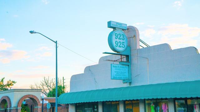 Cityscape image of a historical architecture in Lakeland, FL with a pastel blue and pink sunset behind it.

Source text: https://www.lakelandgov.net/departments/community-economic-development/historic-preservation/
