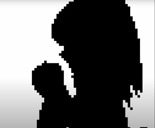 a frame of rendition of Bad Apple, where we see a black silhouette of an anime girl standing and holding an apple, viewed from the side, upon an all-white background. The graphics are blocky using text block glyphs.