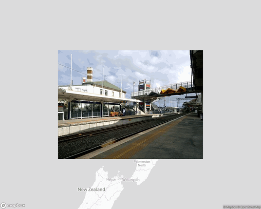 A photo of or from a train station from the linked website, overlaid on a cropped world map where it's located.
