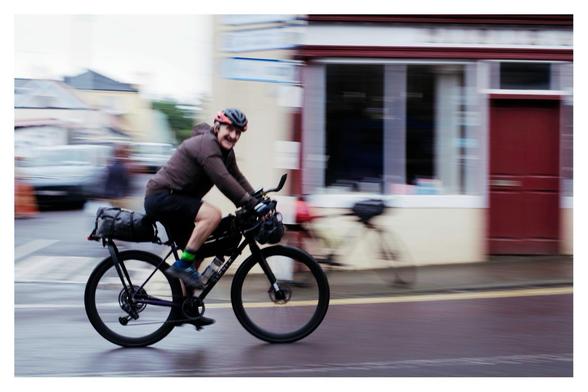 Cyclist in motion on the Trans Atlantic Way cycle race passing through Ballydehob.