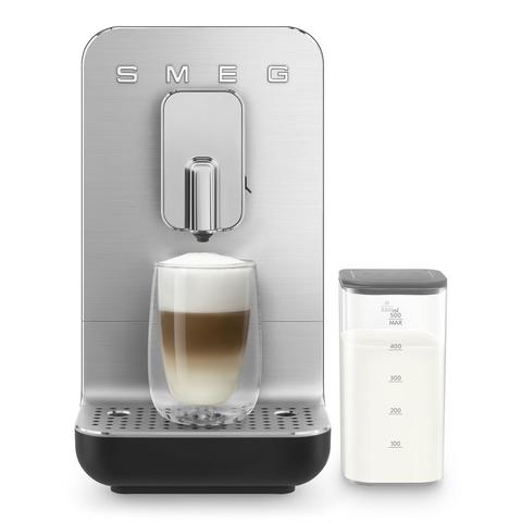 Image of a sleek SMEG coffee machine with a latte in a glass cup and a separate container of milk beside it.