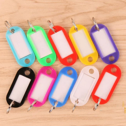 Plastic key tags of assorted colors with inserted labels and clear label covers, and rings attached to put on keys or other items for identification.
