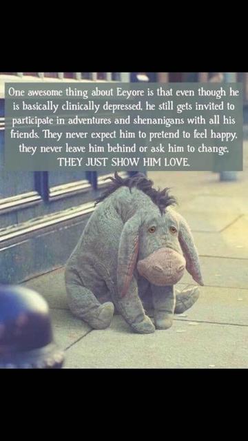 A plush version of Eeyore from "Winnie the Pooh" sits on a sidewalk near a window. His fur is a muted gray with a darker mane and pink inner ears. Above, there is text in a box that reads: "One awesome thing about Eeyore is that even though he is basically clinically depressed, he still gets invited to participate in adventures and shenanigans with all his friends. They never expect him to pretend to feel happy, they never leave him behind or ask him to change. THEY JUST SHOW HIM LOVE."