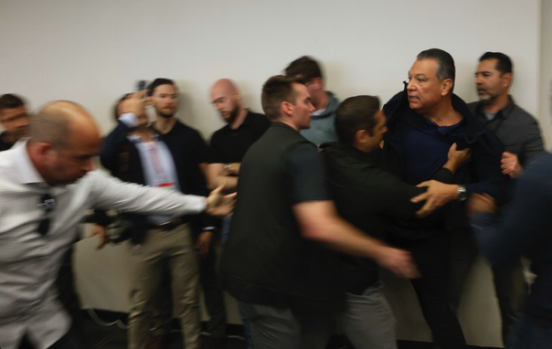 Sen. Alex Padilla (D) is pushed out of the room as Kristi Noem holds a news conference regarding the recent protests in Los Angeles. (Etienne Laurent/AP)