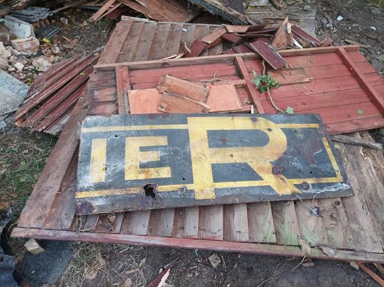 Large black metal sheet with yellow letters, last 3 are IER
