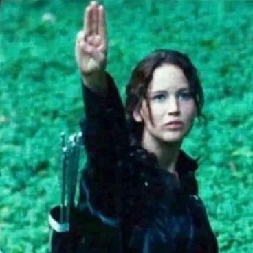 Katniss giving three-finger salute
