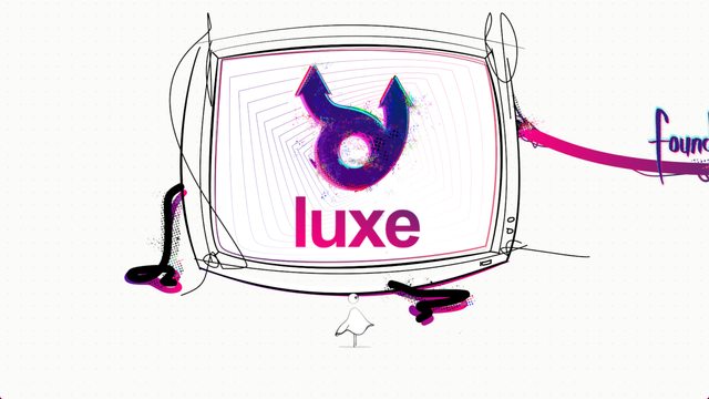 the luxe logo on a big screen in front of a small character!