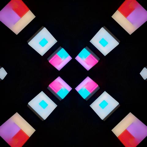Kaleidospic view of colored square patterns over a black background