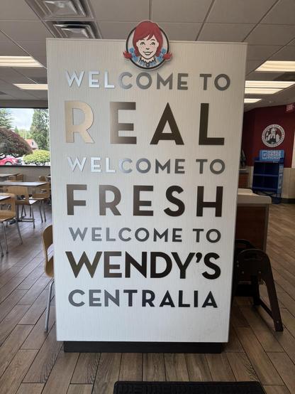 Picture of a Wendy’s sign saying “Welcome to real welcome to fresh welcome to Wendy’s in Centralia”