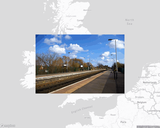 A photo of or from a train station from the linked website, overlaid on a cropped world map where it's located.