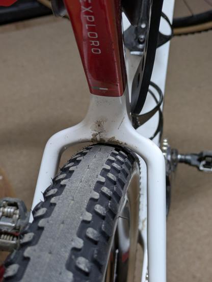 Photo showing very little clearance between the tire and the seatstay bridge on a bicycle.