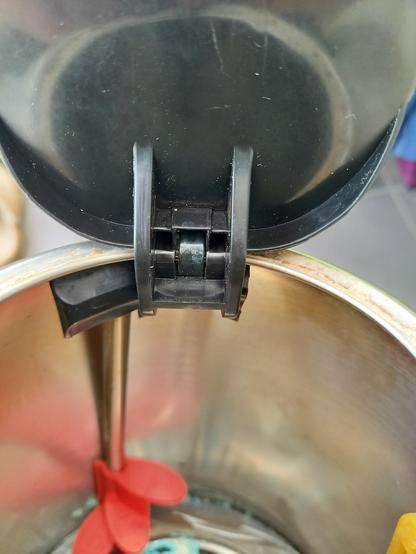 A close-up of the inside of the hinged lid of a kettle.