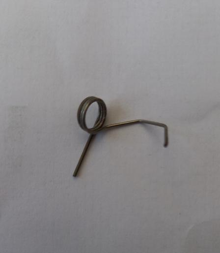 A spring. It has 2 or 3 tight coils. One end goes off at an angle and is bent.