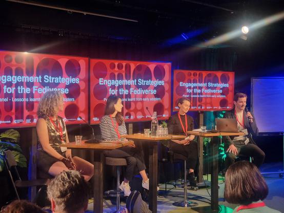 Panel with 4 people behind tables