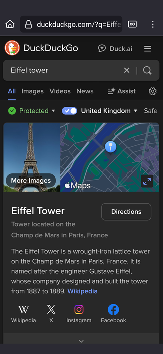 Screenshot of a DuckDuckGo search for the Eiffel Tower.  The results show a picture of the tower, a map and some text from Wikipedia, but no adverts.  The text is in light on black because I use the Dark Reader extension.