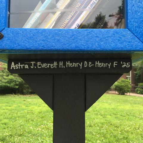 Inscription on the structure holding up the blue box of books:

Astra J. Everett H. Henry D & Henry F '25.