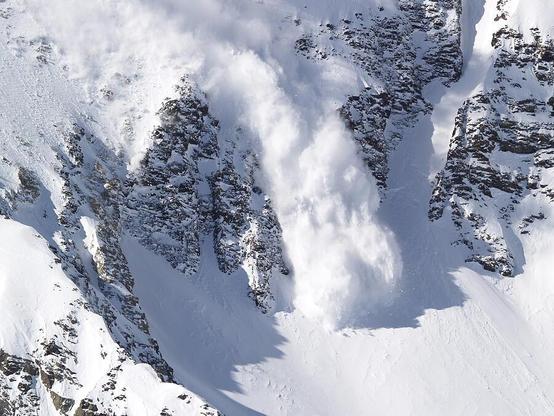Avalanche I

This is an image of an avalanche at the Snowbird Ski Resort outside of Salt Lake City. The avalanche was set off by the Snowbird ski patrol to keep the mountain safe.
Here a large plume of snow is falling over a cliff and just hitting the bowl below the cliff.
This part of the mountain is very steep and the snow shows an incredible force as it burst into the bowl.