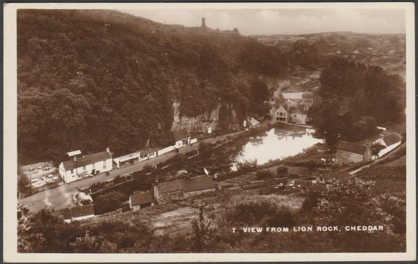 Sepia real photographic postcard showing a view of the village of Cheddar in Somerset from Lion Rock.

Publisher not stated, No 7, c.1920s.

Postally unused.

Very good condition, with very slight corner bumps and light album marks.