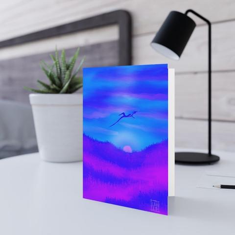 A simplistic dragon against an evening sky; the sun is setting in an orgy of pinks and purples, with pink and blue mountains below.