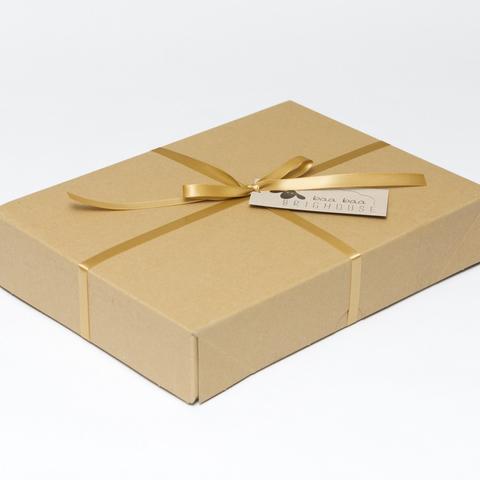 Picture shows a closed A4 box tied with gold ribbon.