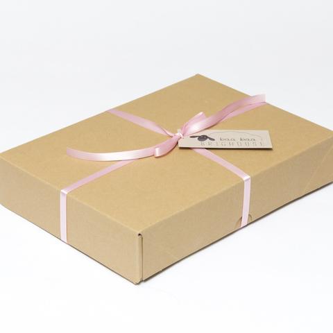 Picture shows a closed A4 box tied with pink ribbon.