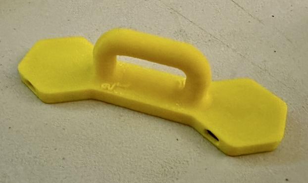 Yellow 3D printed magnet assembly with a handle and two neodymium magnets embedded.