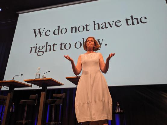 Maria in front of her slide saying “We do not have the right to obey.”