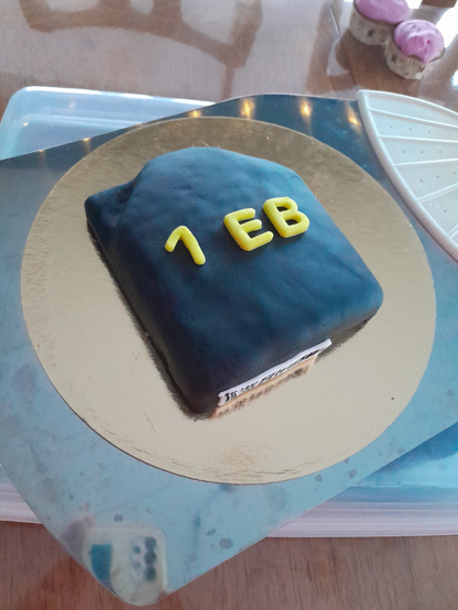 A cake in the shape of a tape cartridge, with "1 EB" on the top and a barcode on the side.
