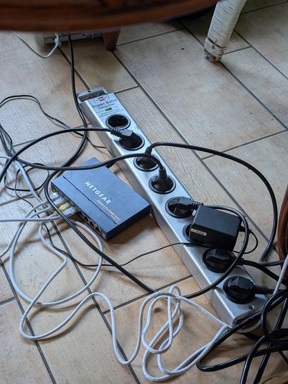 A picture of an eight socket extension cable, with 7 plugs in